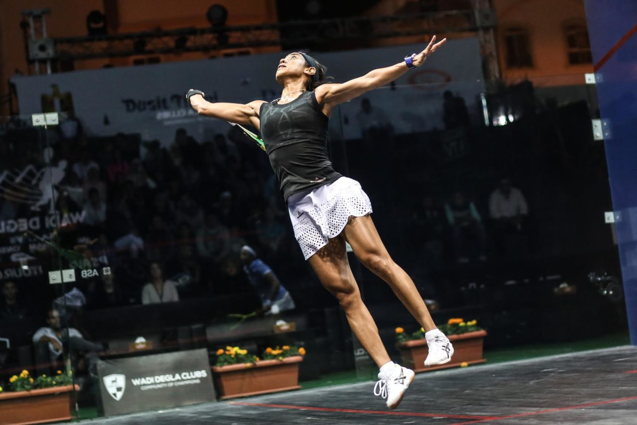 Nicol David leaps through the air to volley
